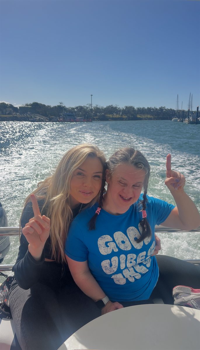 Two people out on a boat on a sunny day