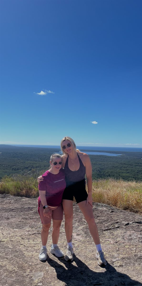 Two people at a lookout with a view over the hills
